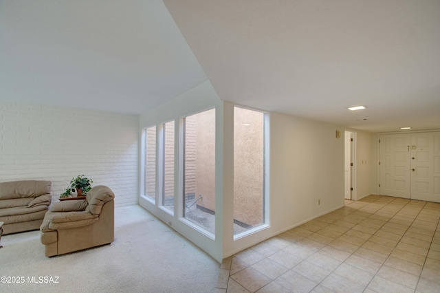 living room featuring a wealth of natural light and brick wall