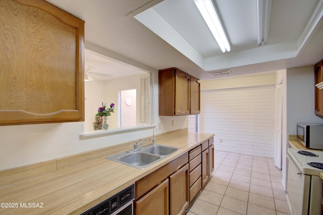 kitchen with ceiling fan, sink, electric range, black dishwasher, and light tile patterned flooring