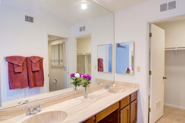 bathroom with tile patterned floors, ceiling fan, a shower with shower door, and vanity