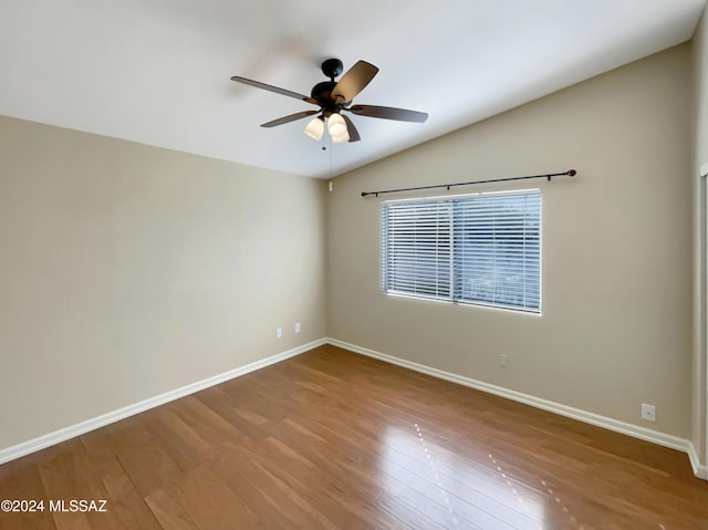 spare room featuring hardwood / wood-style floors, ceiling fan, and lofted ceiling