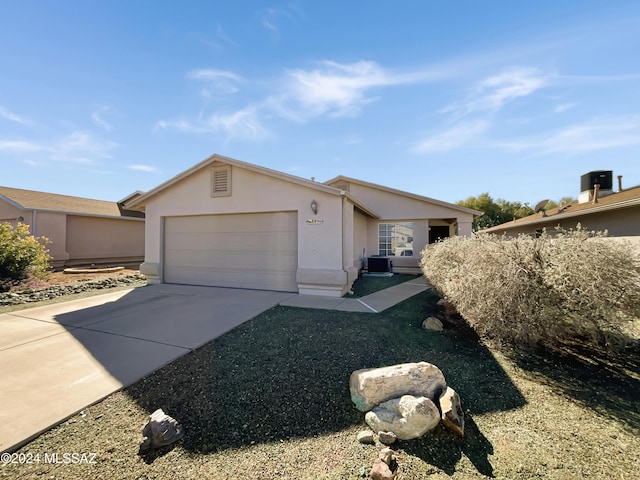 ranch-style house with a garage and central AC