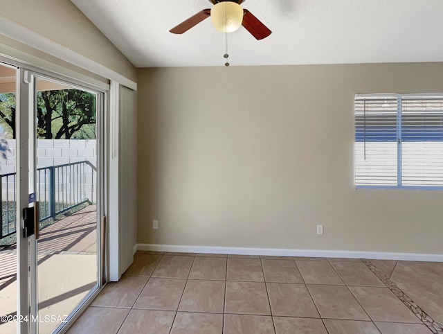 tiled empty room with ceiling fan and lofted ceiling