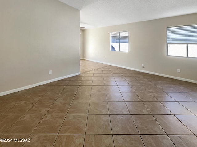 spare room with a textured ceiling