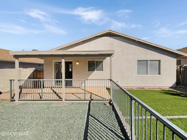 back of house featuring a yard