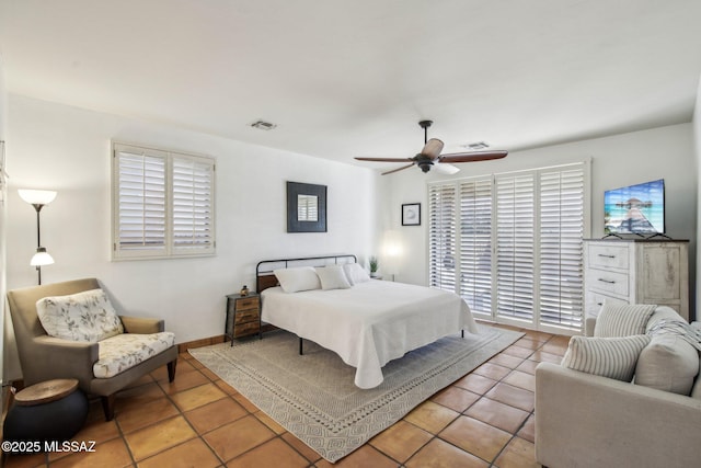 bedroom with ceiling fan and light tile patterned floors