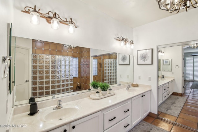 bathroom featuring tile patterned floors, a wealth of natural light, vanity, and a chandelier