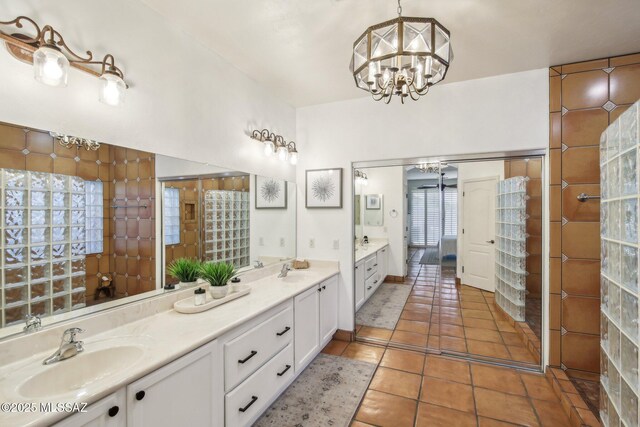 bathroom with vanity, tile patterned floors, and a notable chandelier