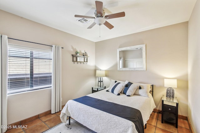 tiled bedroom featuring ceiling fan