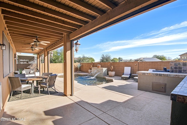 view of patio / terrace with pool water feature, a fenced in pool, and ceiling fan