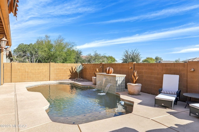 view of pool with pool water feature and a patio