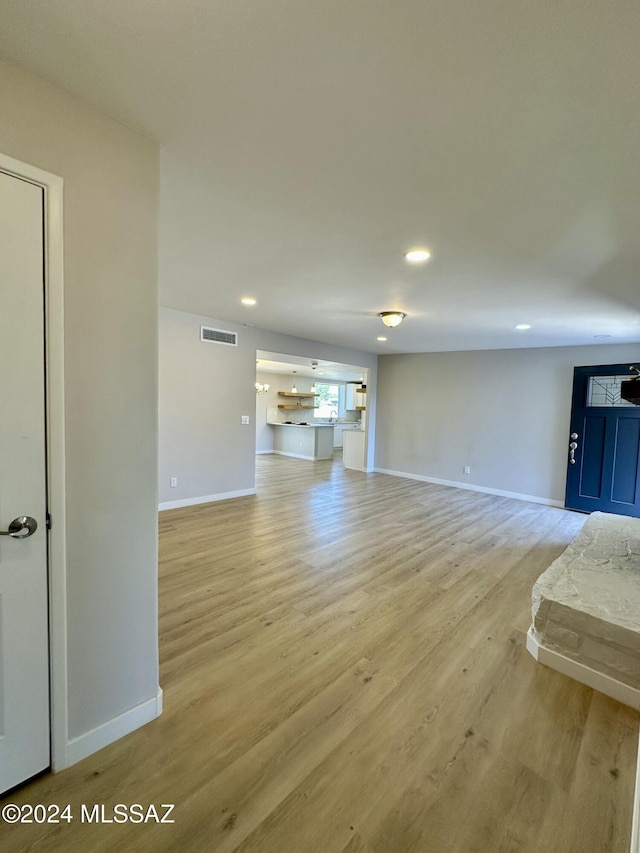 unfurnished living room featuring light wood-type flooring