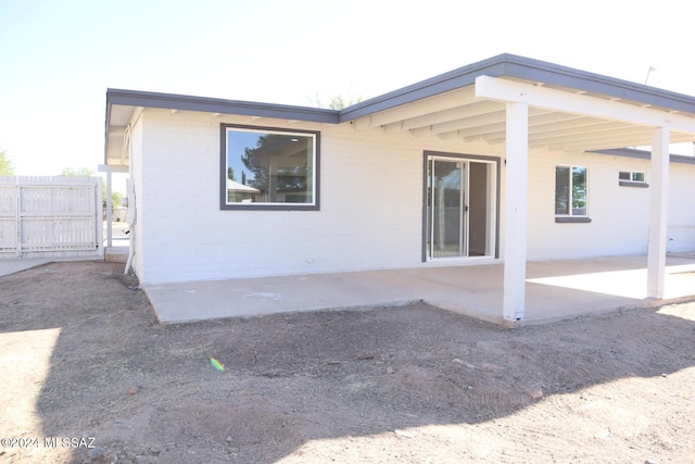 back of property with a patio