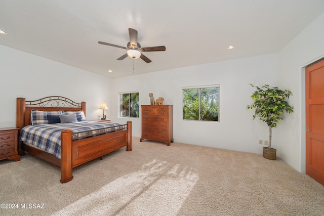 bedroom featuring ceiling fan and light carpet