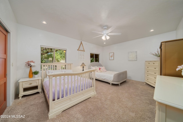 bedroom with light colored carpet and ceiling fan