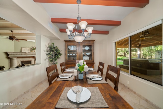 dining area featuring beam ceiling and ceiling fan with notable chandelier