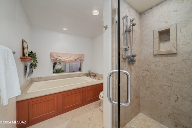 bathroom with tile patterned floors, toilet, and independent shower and bath