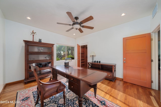 home office with ceiling fan and light hardwood / wood-style floors