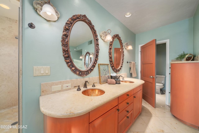 bathroom featuring tile patterned flooring, vanity, and toilet