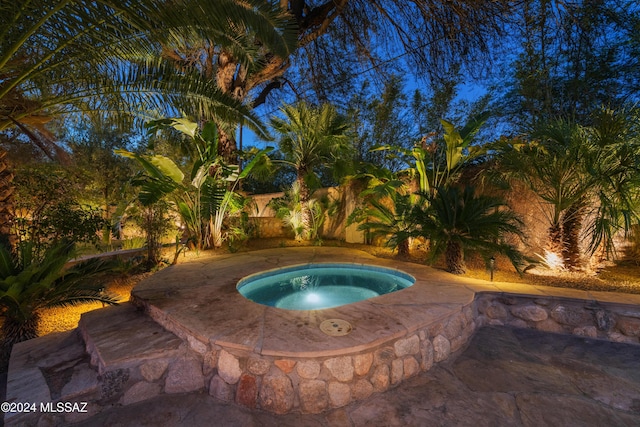 view of pool featuring an in ground hot tub