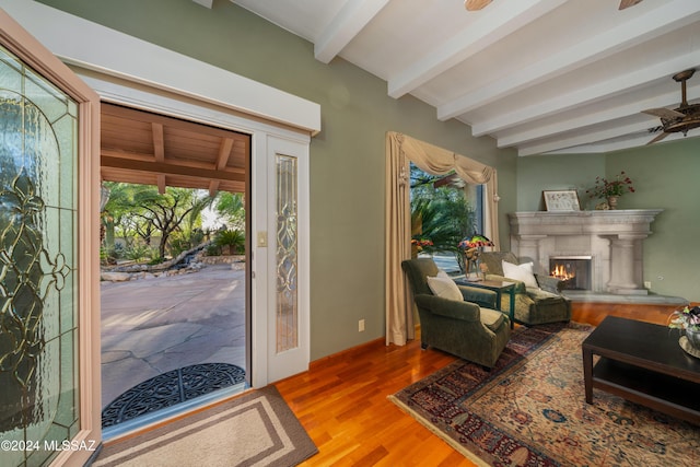 entryway featuring beam ceiling, ceiling fan, and wood-type flooring