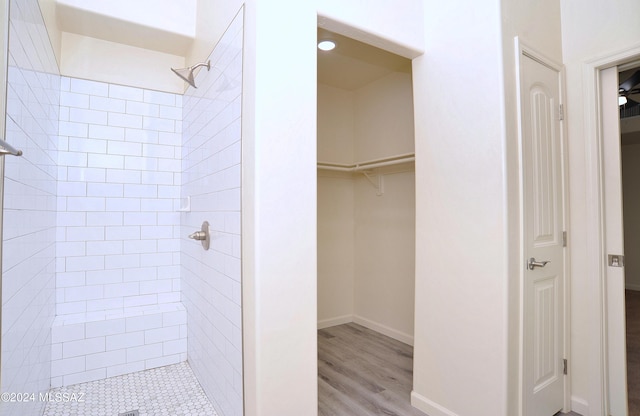 bathroom featuring tiled shower and hardwood / wood-style floors