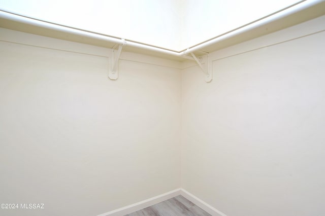 walk in closet featuring light hardwood / wood-style floors