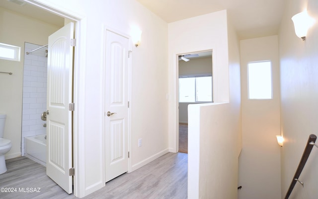 corridor with light hardwood / wood-style flooring