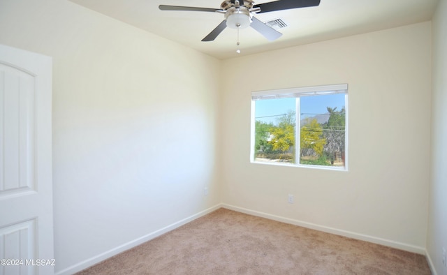 empty room featuring light colored carpet and ceiling fan