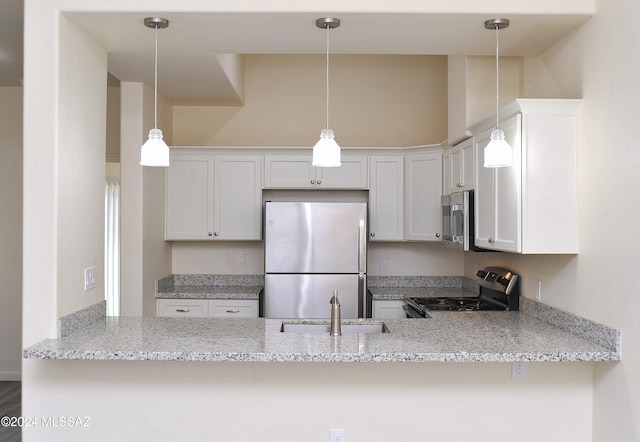 kitchen with white cabinets, stainless steel appliances, kitchen peninsula, and light stone counters