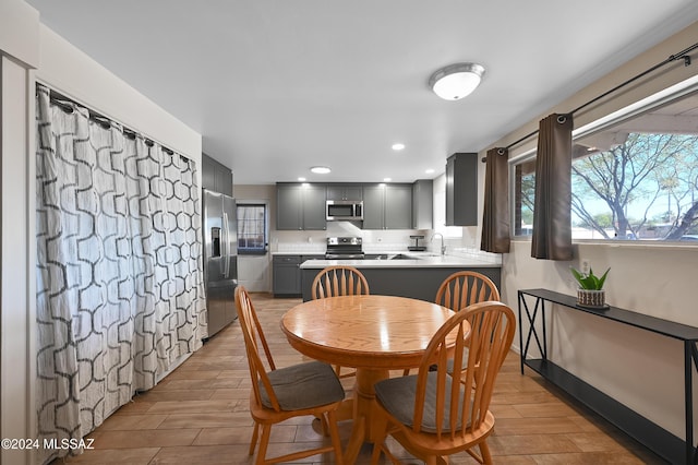 dining room with sink and light hardwood / wood-style flooring