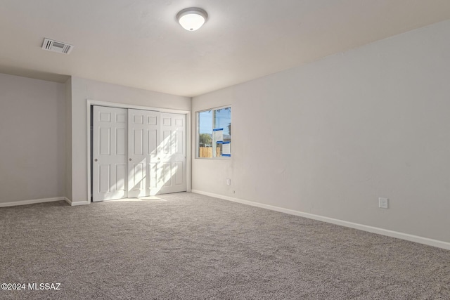 unfurnished bedroom with carpet and a closet