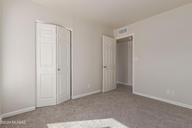 unfurnished bedroom with carpet floors and a closet