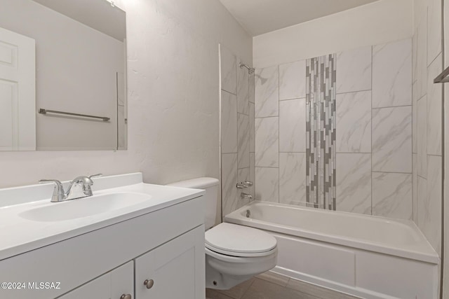 full bathroom featuring vanity, tiled shower / bath combo, and toilet