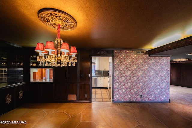 unfurnished dining area with an inviting chandelier