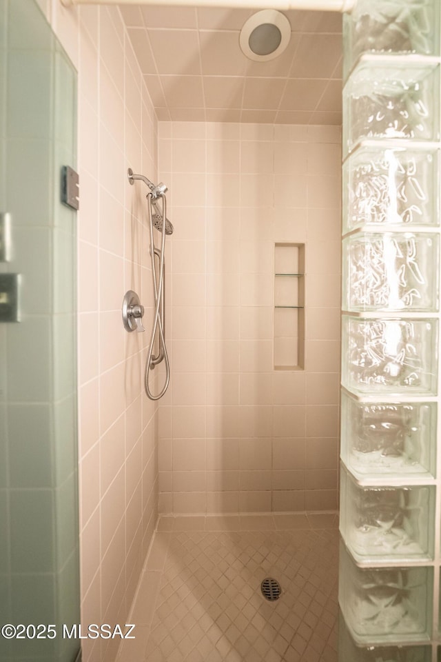 bathroom with tiled shower