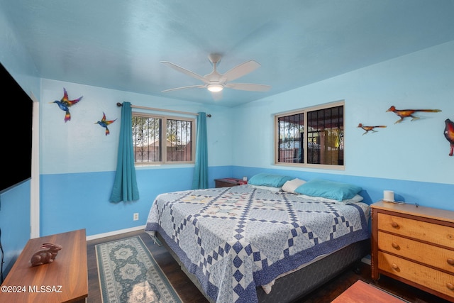 bedroom with ceiling fan and dark wood-type flooring