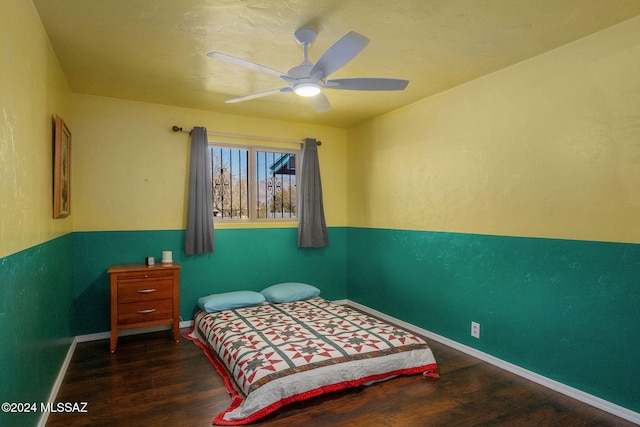 bedroom with dark hardwood / wood-style floors and ceiling fan