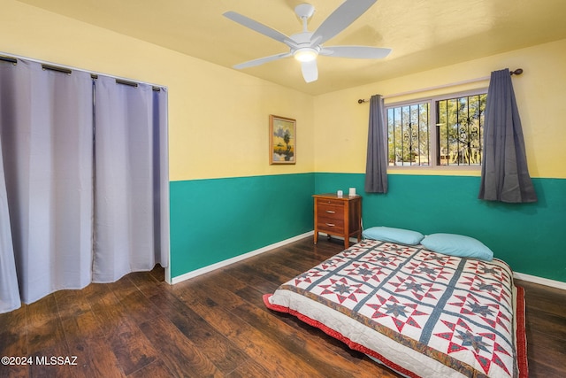 bedroom with ceiling fan and dark hardwood / wood-style floors