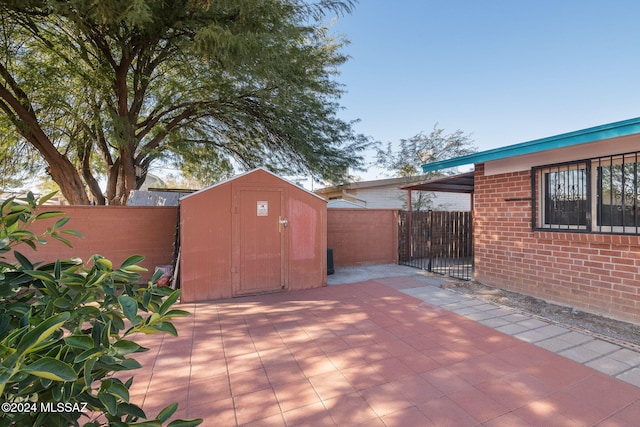 view of patio / terrace with a storage shed