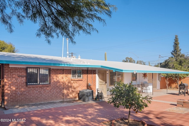 back of property featuring a patio area and central air condition unit