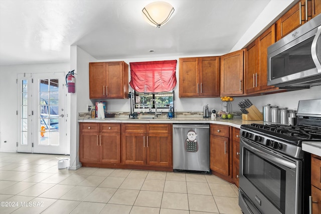 kitchen featuring light tile patterned floors, sink, and appliances with stainless steel finishes