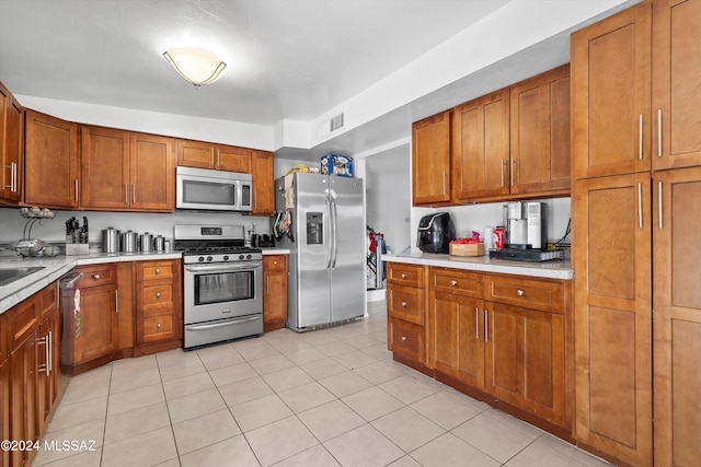 kitchen featuring appliances with stainless steel finishes and light tile patterned flooring