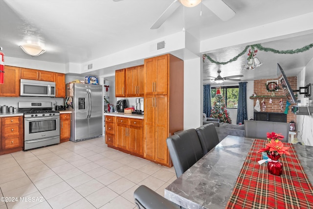 kitchen with ceiling fan, light tile patterned floors, and appliances with stainless steel finishes