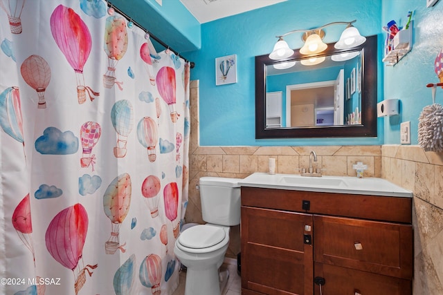 bathroom featuring vanity, a shower with shower curtain, tile walls, and toilet