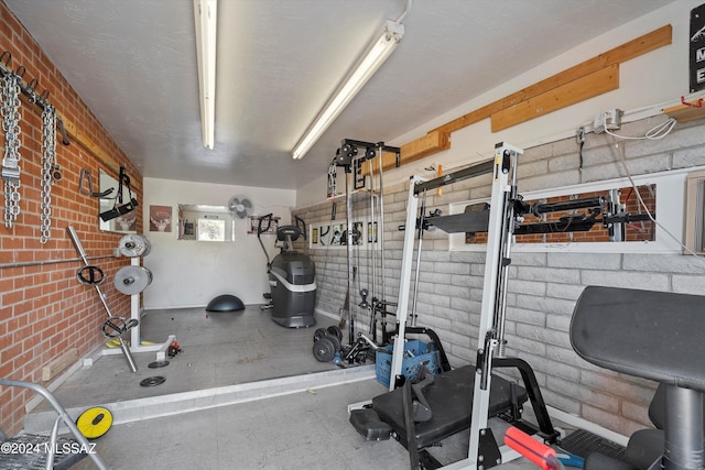 exercise area featuring brick wall