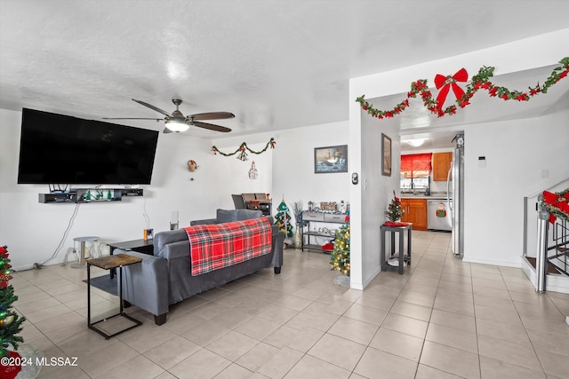 living room with ceiling fan and light tile patterned flooring