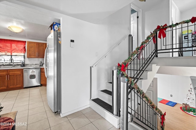 staircase featuring sink and tile patterned flooring