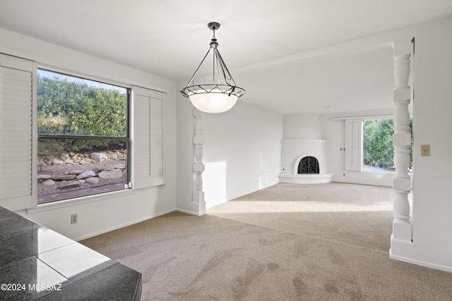 unfurnished living room with a large fireplace and carpet floors