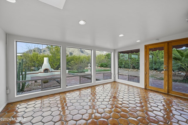 unfurnished sunroom featuring plenty of natural light and french doors