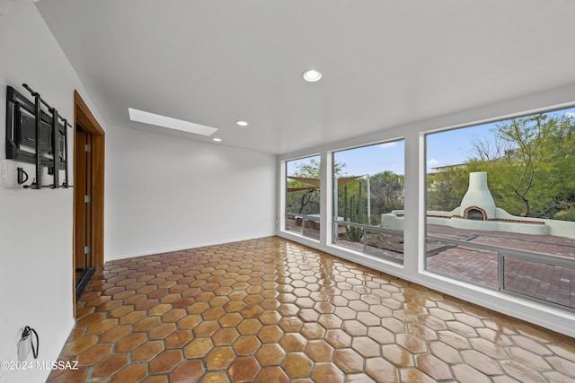 sunroom / solarium featuring a skylight